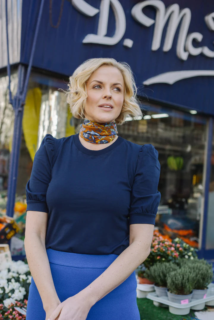 Model wearing a scarf and a navy Livotte shirt